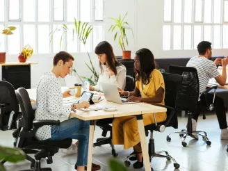 Office workers working at co-working desk