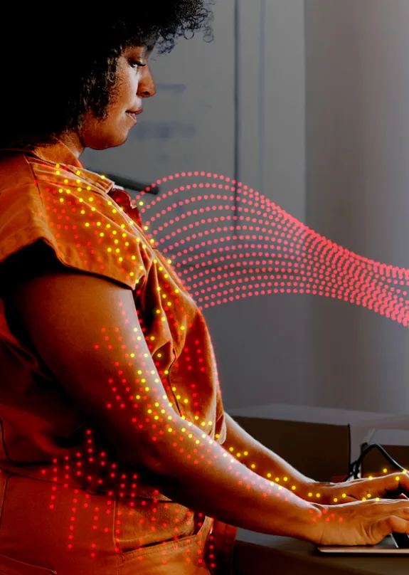 Female business owner using a laptop in her clothing store